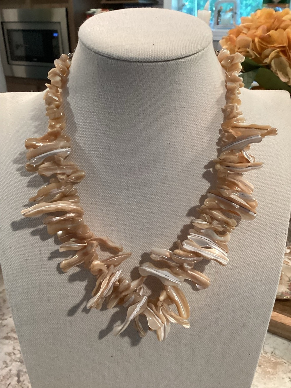 Iridescent mother of pearl branch necklace features irregular elements